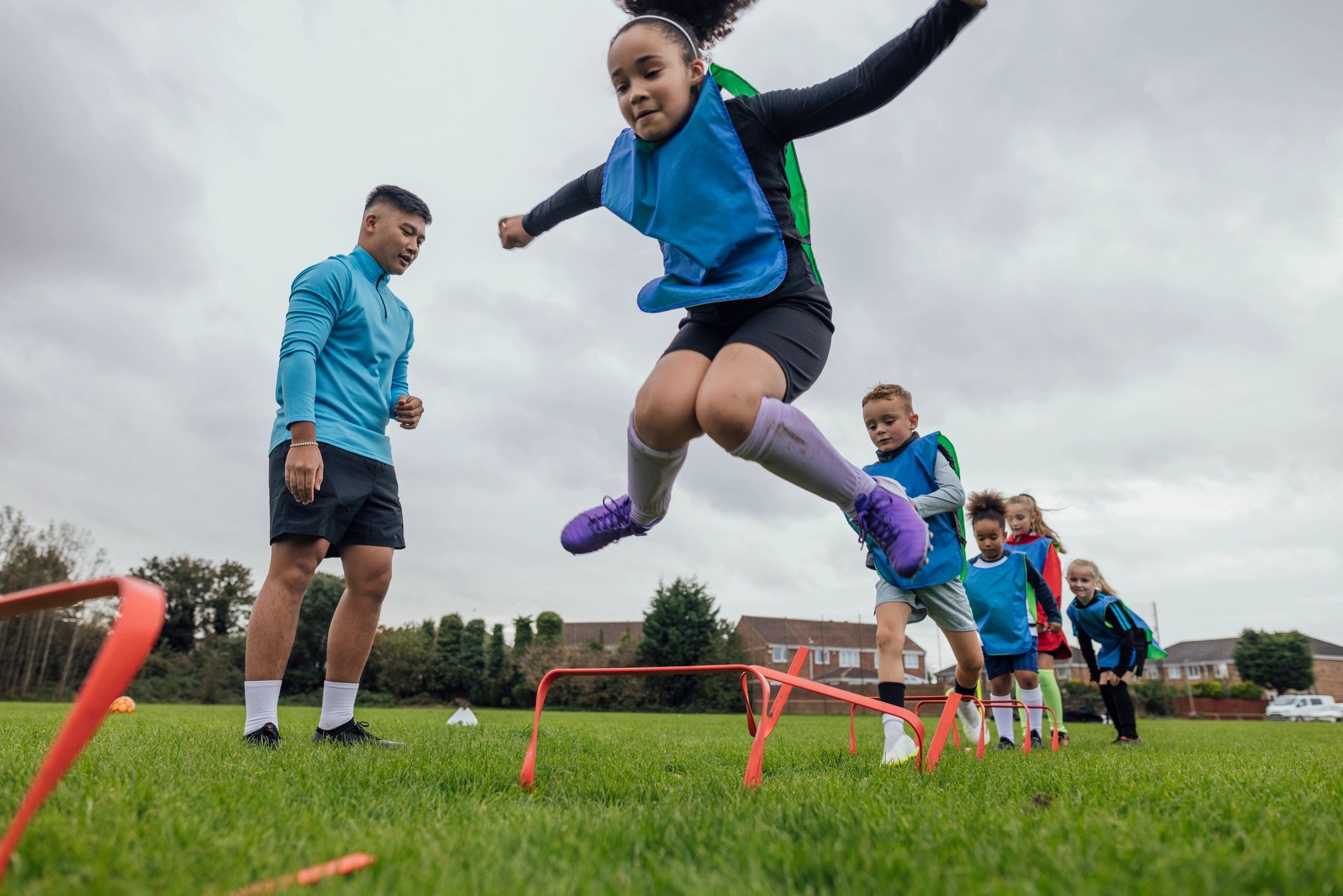 Coach leading agility drills for youth soccer players